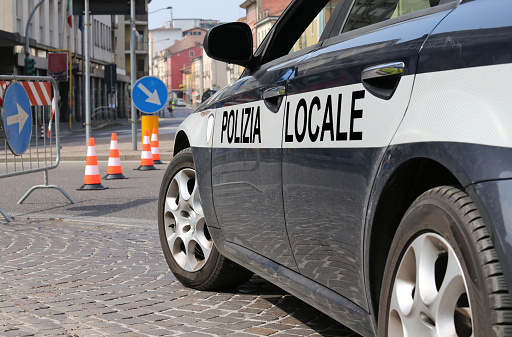 italian local police car during the roadblock in the way of the city