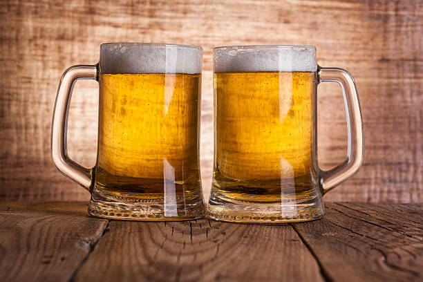 istock Glass beer on wood background 473563520