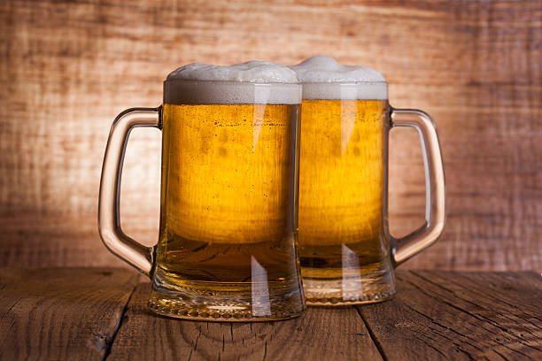 istock Glass beer on wood background 473563738