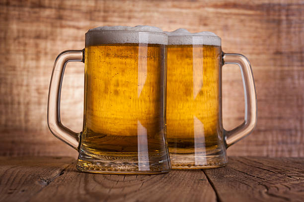 istock Glass beer on wood background 473565670