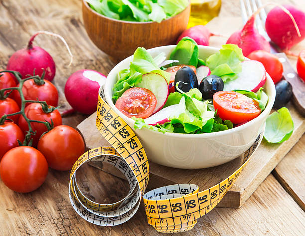 istock Vegetables Salad with Measure Tape.Healthy Diet 473565726