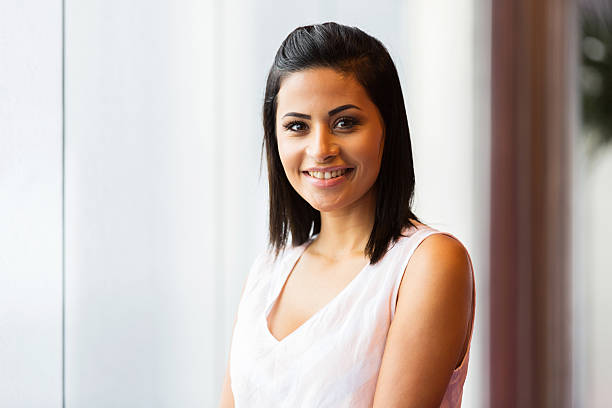 istock young woman standing in front of window 473566204