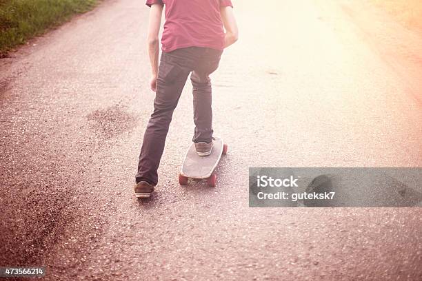 Boy Cruising On A Longboard Stock Photo - Download Image Now - 2015, Activity, Adult