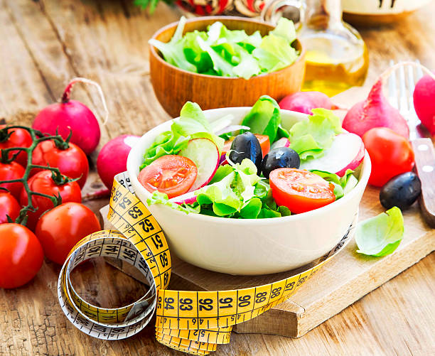 istock Healthy Vegetables Salad with Measure Tape.Diet Concept 473569178
