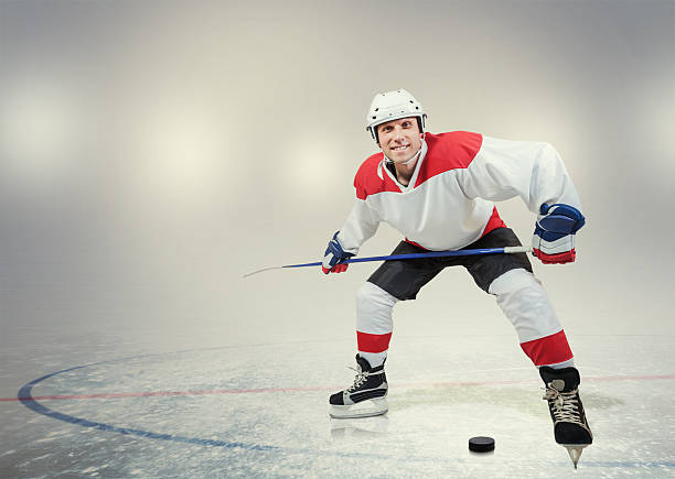 istock Smiling hockey player on ice 473571700