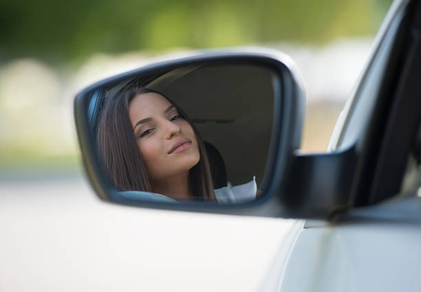 istock Woman face car mirror 473572020