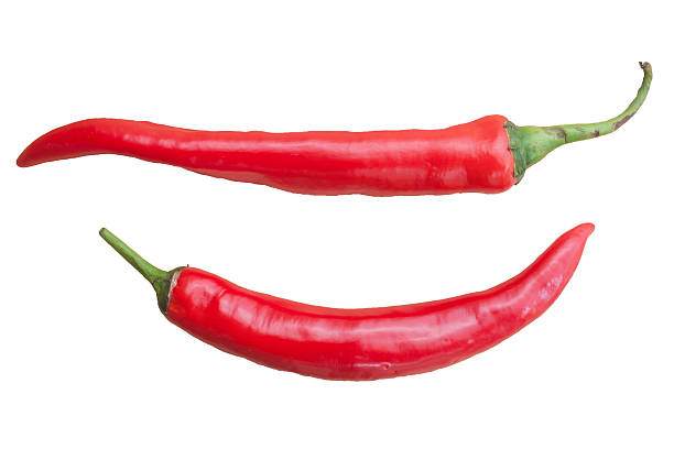 istock Chili isolated on wood background 473572394