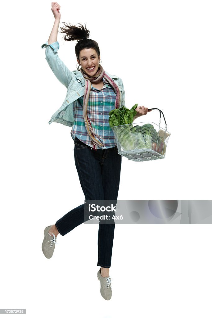 Female holding vegetable basket and jumping Female holding vegetable basket and jumpinghttp://www.twodozendesign.info/i/1.png One Woman Only Stock Photo