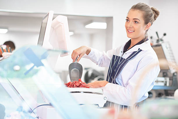 istock young female butcher portrait 473573578