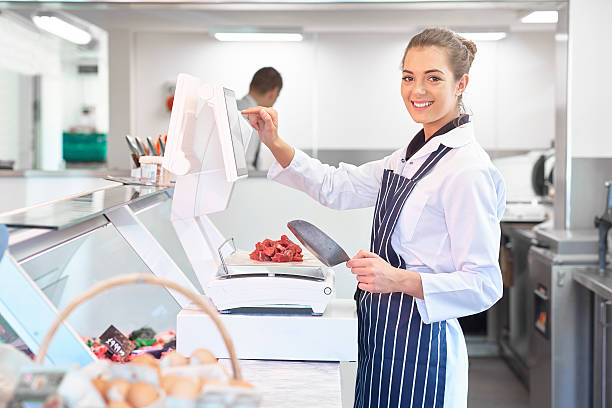 istock young female butcher portrait 473573606