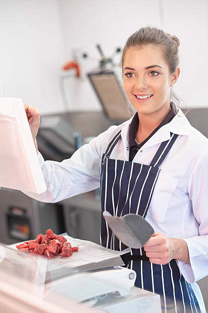 istock young female butcher portrait 473573642