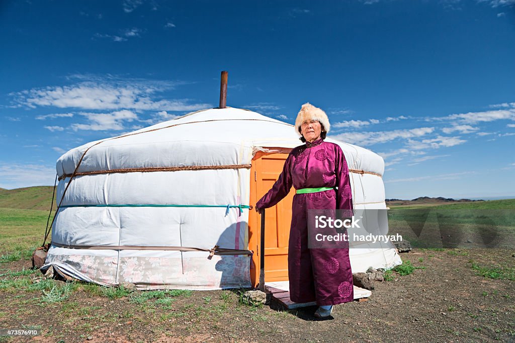 Mongolian woman in national clothing standing next to ger Mongolian woman in national clothing, ger (yurt) in the background.http://bem.2be.pl/IS/mongolia_380.jpg Independent Mongolia Stock Photo