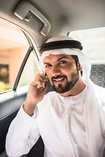 istock sheik on the phone inside a taxi 473576958