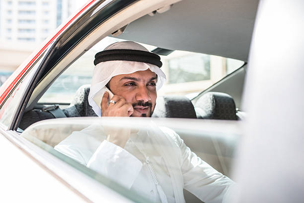 istock sheik on the phone inside a taxi 473577100