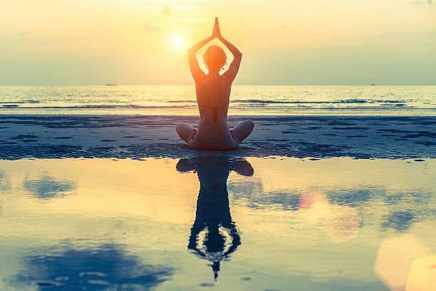 istock Silhouette of a young girl practicing yoga 473577554