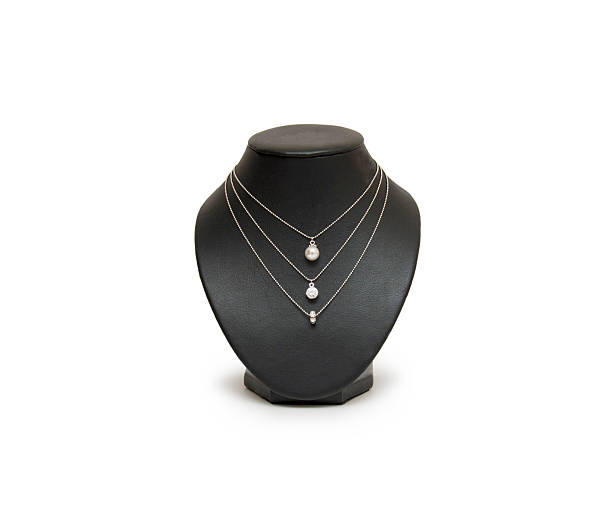 istock Diamond necklace on black mannequin isolated on white background 473578872