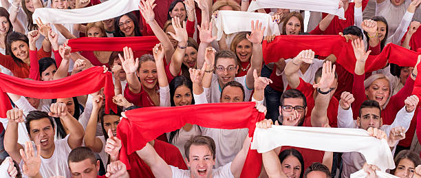 istock High angle view of group of ecstatic fans cheering. 473581872