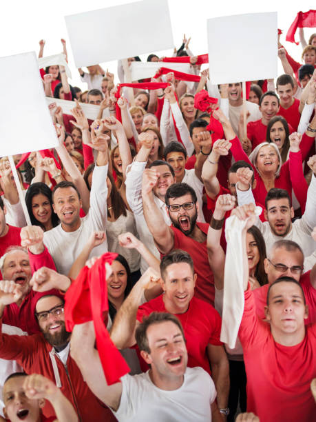 istock Group of ecstatic fans holding white banners and cheering. 473581878