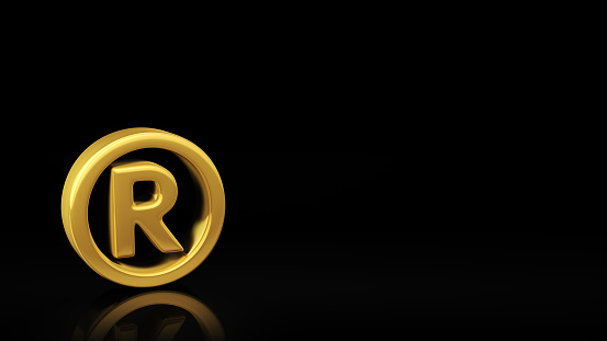 Gold registered symbol on black background with reflection and copyspace. Good for copyrights slide with text