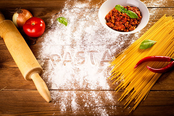 ingredients for spaghetti on a wooden table stock photo