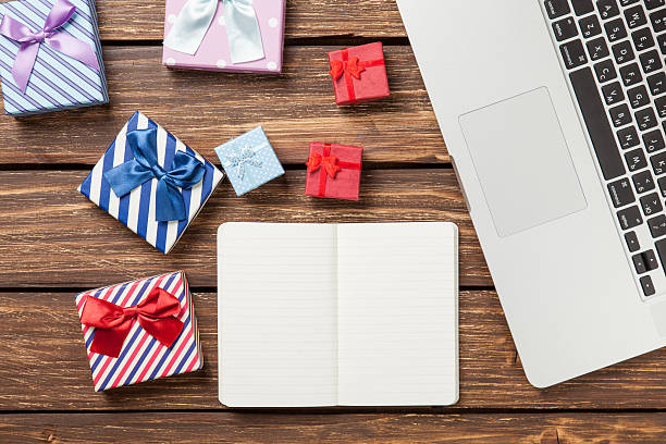 istock Note with gifts and laptop 473582910