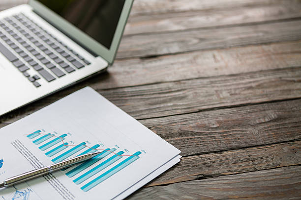 istock Financial charts on the table with laptop 473583144