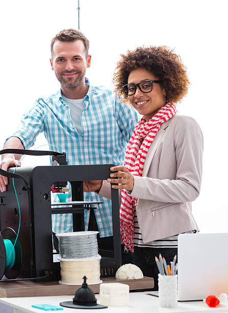 istock Woman and man in 3D printer office 473583496