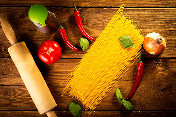 ingredients for spaghetti on a wooden table stock photo