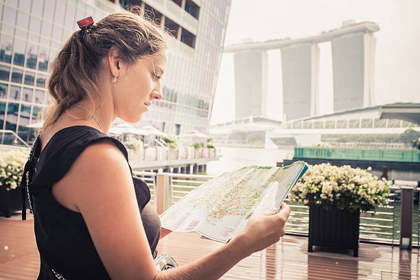 istock Female tourist looking at a map 473588742
