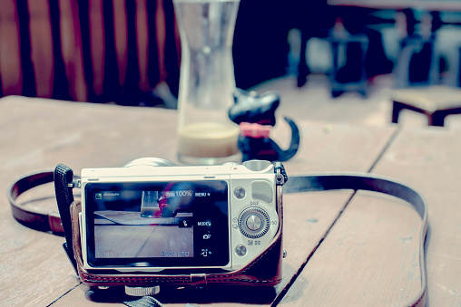 Digital Camera taking photograph on Table