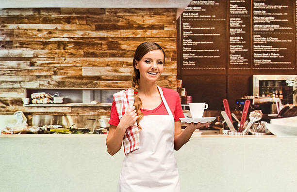 istock Female barista holding a drink 473594142