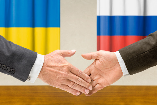 Representatives of  Ukraine and Russia shake hands