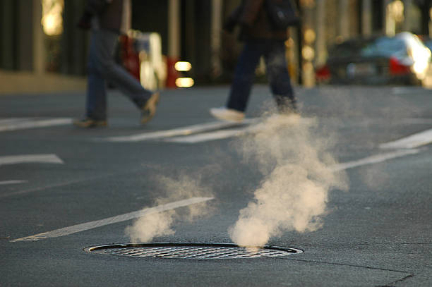 Nordhorn, Germany Aug 19 2016 Before the shops open, the shopping street is cleaned by municipal cleaning staff. A cleaner uses a high pressure sprayer to clean a concrete structure.