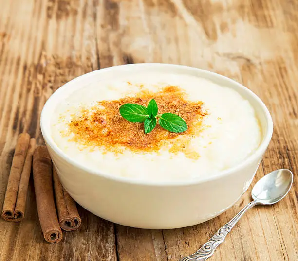Vanilla Rice Pudding with Cinnamon Powder and Mint Leaf, Delicious Dessert