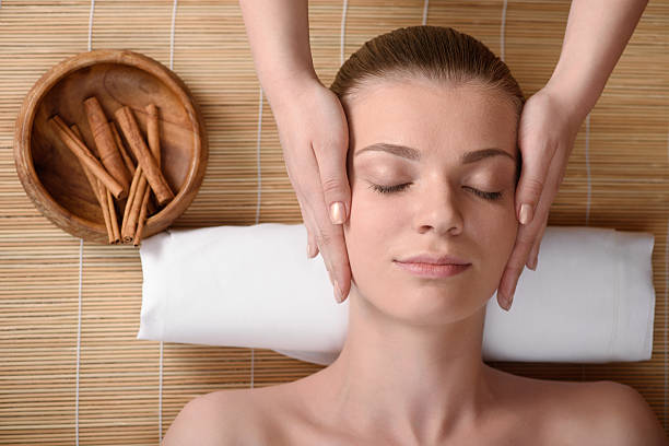 istock Beautiful young woman getting relaxing head massage. Top view 473599406