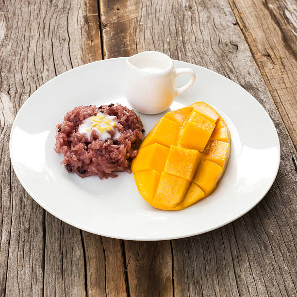 Mango with sticky rice and  coconut milk topping. Traditional dessert of thailand. Favorite dessert in summer time.