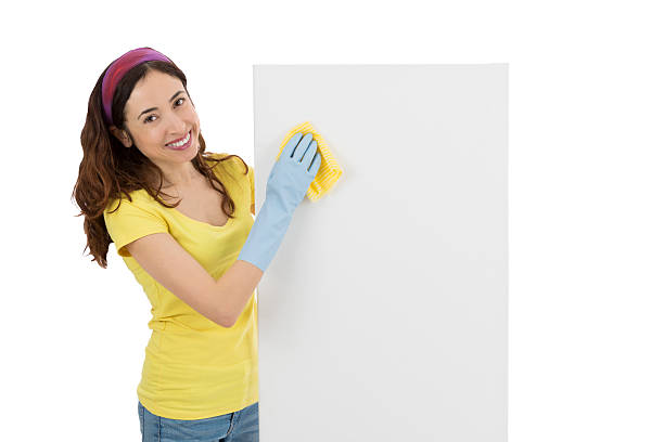 istock Spring cleaning woman wiping a blank advertising board 473602856