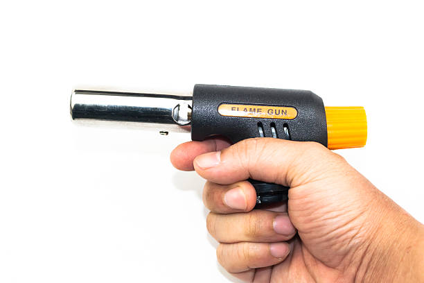 istock hand holding gas cooking flame gun isolated 473603226