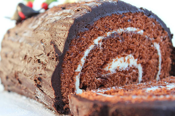 istock Image of Christmas chocolate log / Swiss roll with frosting / icing 473604402