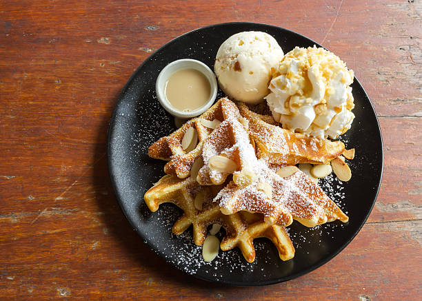 istock Waffle with icecream on black plate. 473606544