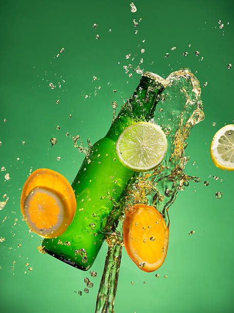 istock Bottle of fruit beer with splash, on gree 473609260