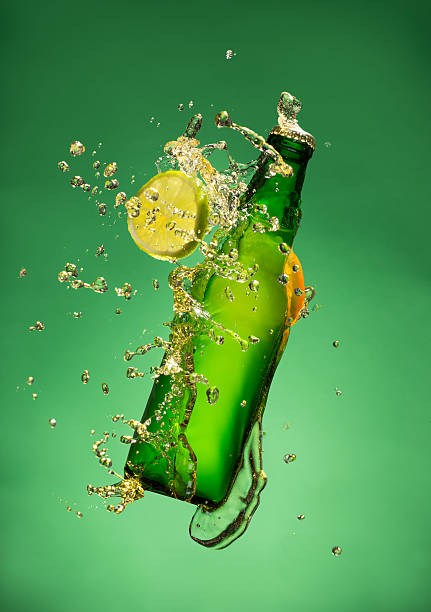 istock Bottle of fruit beer with splash, on gree 473609262