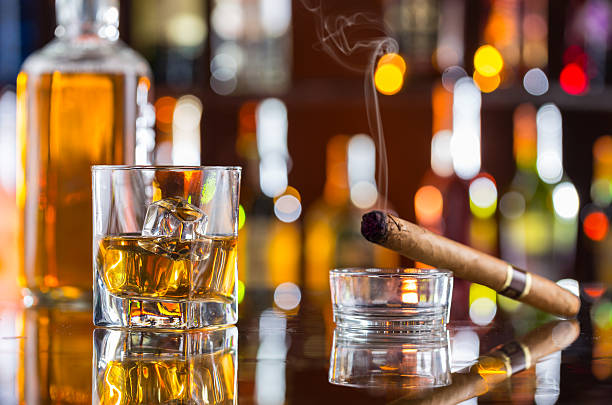 istock Whiskey drink with smoking cigar on bar 473609318