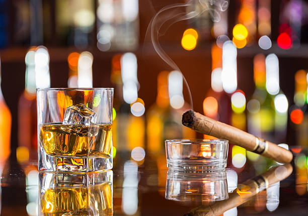 istock Whiskey drink with smoking cigar on bar 473609322