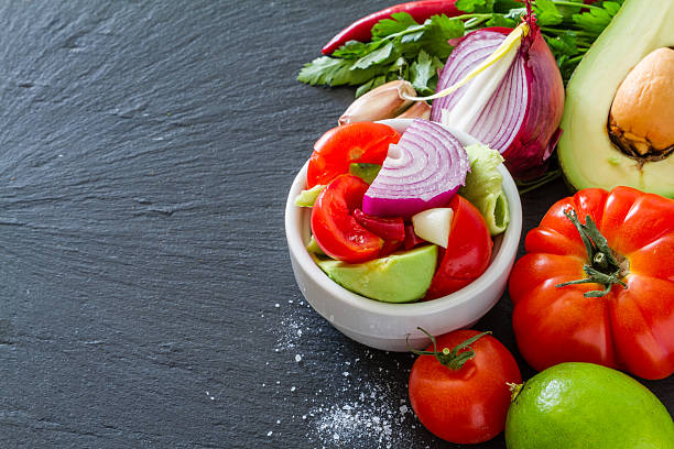 istock Guacamole ingredients - avocado, tomatoes, onion, garlic, lime, parsley 473611706