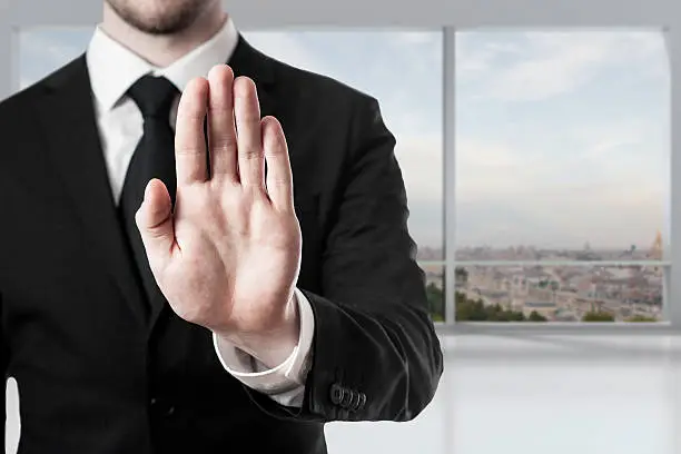 Photo of businessman in office hand stop gesture