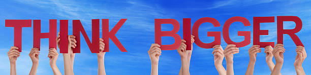 istock Hands Hold Red Straight Word Think Bigger Blue Sky 473616060
