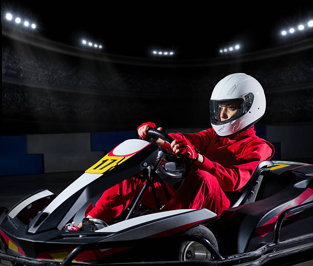 istock Girl karting racer at stadium 473617022