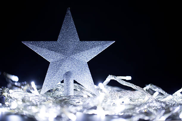 istock Christmas star with Christmas lighting bulbs 473617222