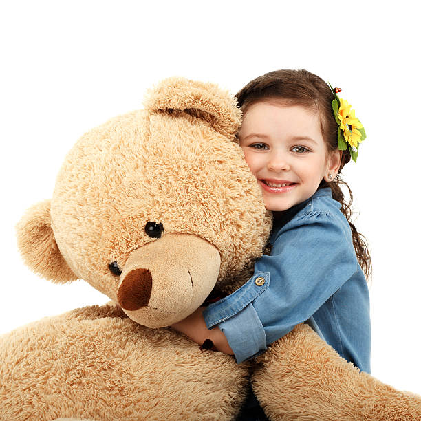 istock Little girl with big teddy bear having fun laughing 473617372